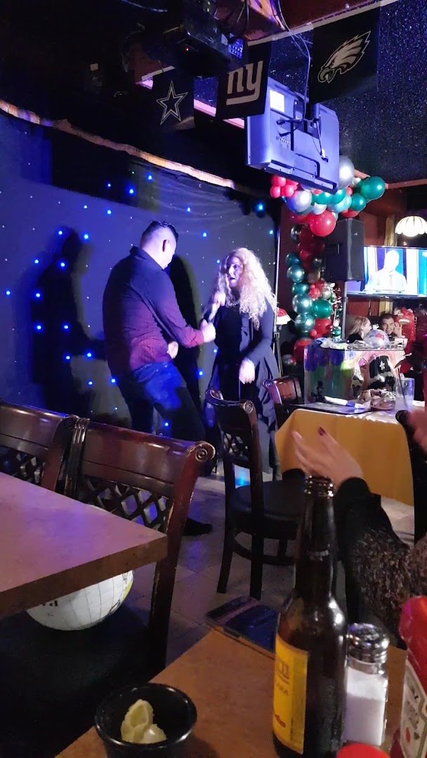 Casual restaurant seating beside a bar.